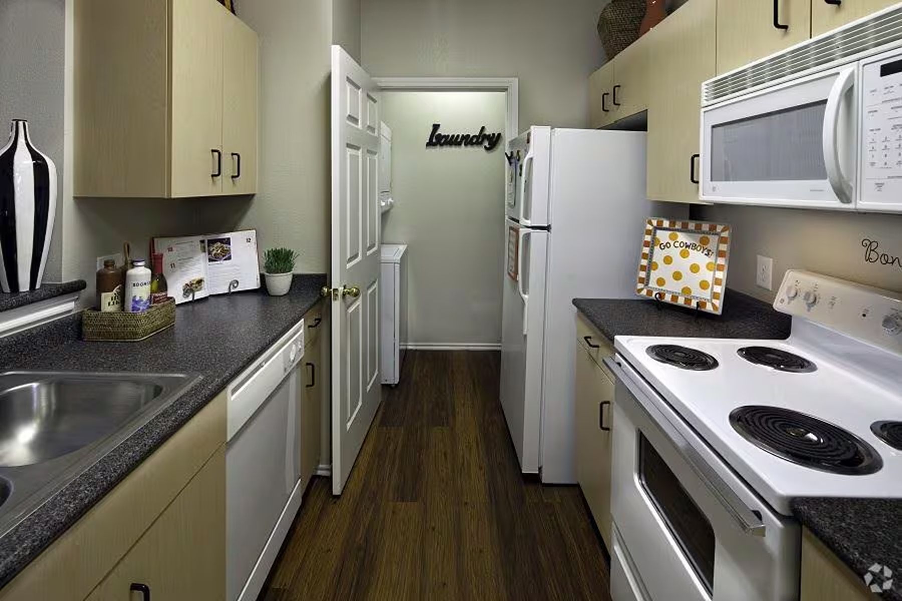 Student apartment kitchen at Milestone Stillwater with full-size appliances and overhead cabinets.