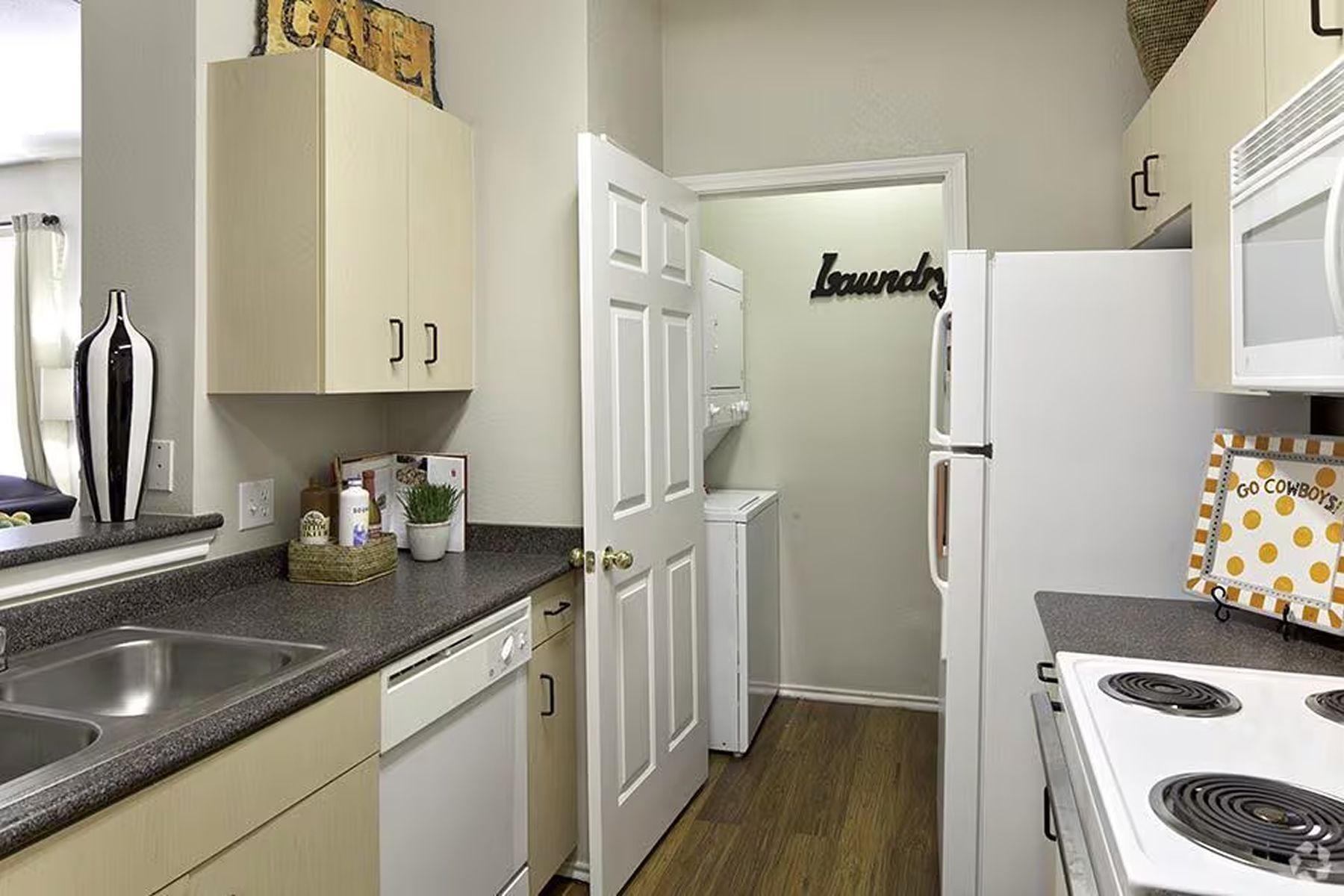 Updated Milestone Stillwater apartment kitchen with white cabinets and modern finishes.