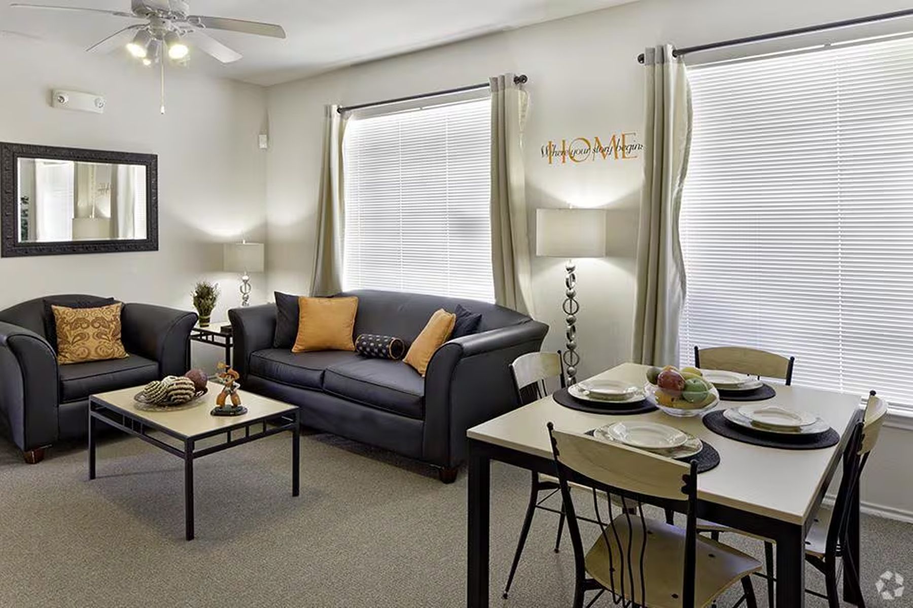 Spacious furnished living room at Milestone Stillwater with dining table and natural light.