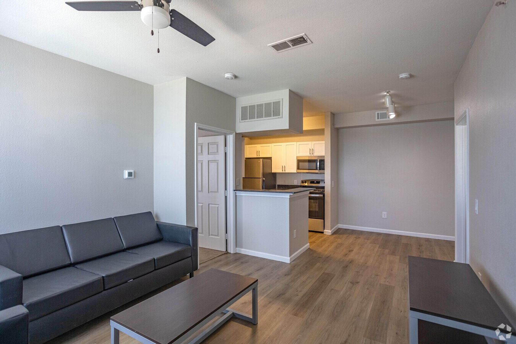 Open-layout living room and kitchen area at Milestone Stillwater student housing.