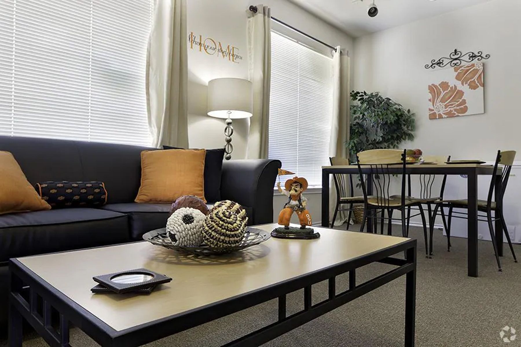 Furnished living room at Milestone Stillwater with sofa, coffee table, and dining area.