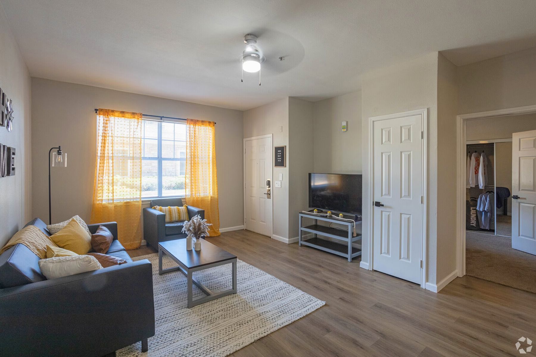 Furnished living room inside Milestone Stillwater student apartments with natural lighting and modern décor.