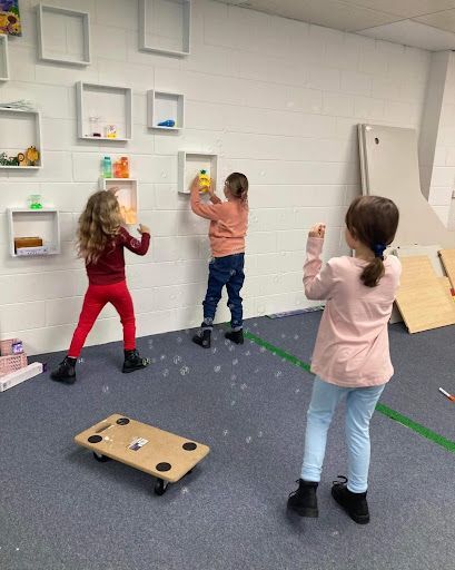 Three Young Girls Are Playing With Bubbles in a Room — Learn to Live in Currajong, QLD