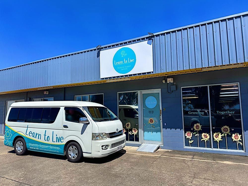 A White Van is Parked in Front of a Building — Learn to Live in South Townsville, QLD