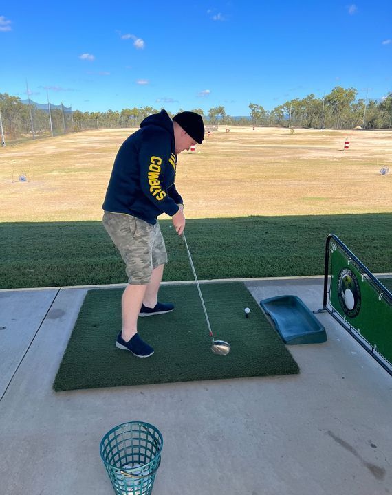 Golfer Swings Club on Vibrant Green Fairway — Learn to Live in Currajong, QLD