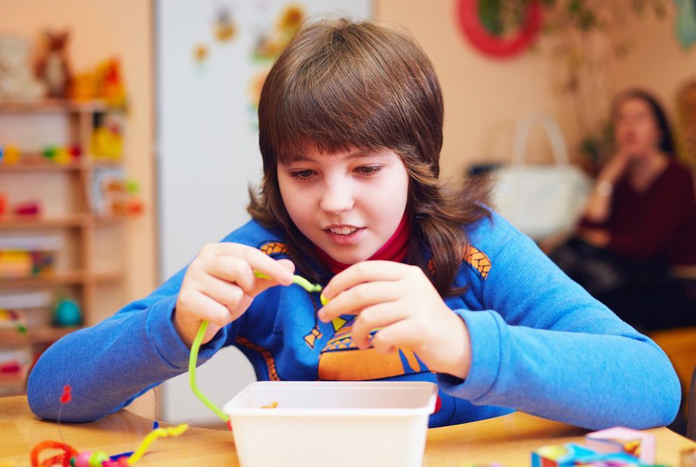 A Boy Enjoying Playtime With a Toy in a Bright Room — Learn to Live in Currajong, QLD