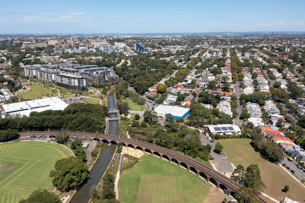 Aerial View of City With River and Bridge — Learn to Live in Annandale, QLD