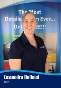 Woman in navy polo shirt, glasses, smiles. Reads 