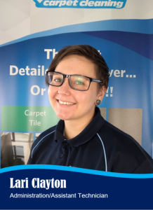 Woman in navy polo shirt, glasses, smiles. Reads 