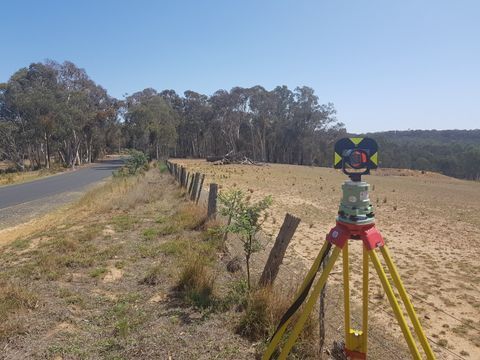 Tripod Is Placed In The Middle Of A Field Next To A Road — Surveyor In Canowindra, NSW