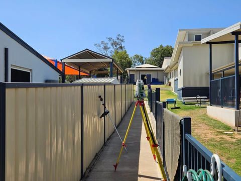 Surveyor On A Sidewalk Next To A Fence — Surveyor In Cowra, NSW