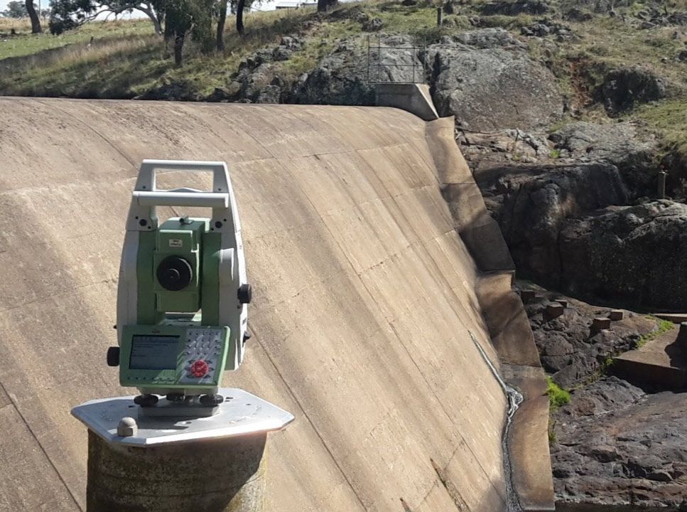 Dam Concrete Wall With Surveyor Device — Surveyor In Canowindra, NSW