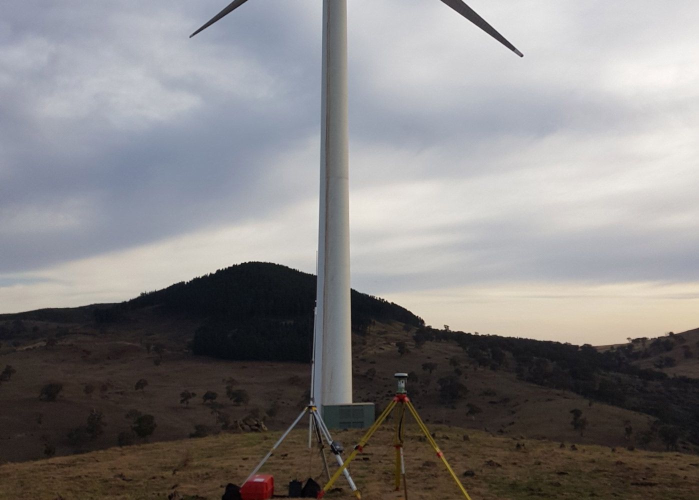 Wind Turbine On Top Of A Hill With A Surveyor In Front Of It — Surveyor In Canowindra, NSW