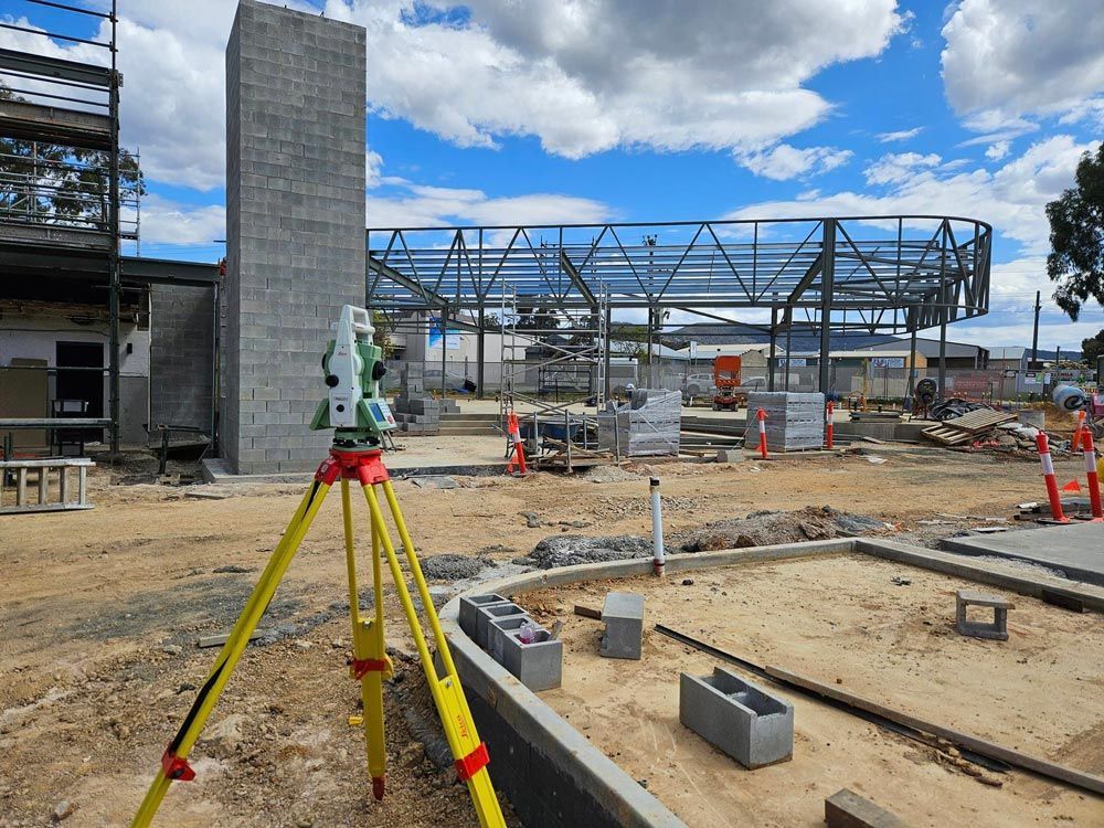 Construction Site With A Red And Yellow Surveyor — Surveyor In Canowindra, NSW