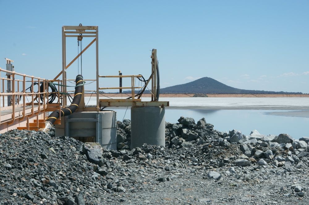 Industrial Pipe Line on The Bank of Lake with Mountains in Background  — Surveyor In West Wyalong, NSW