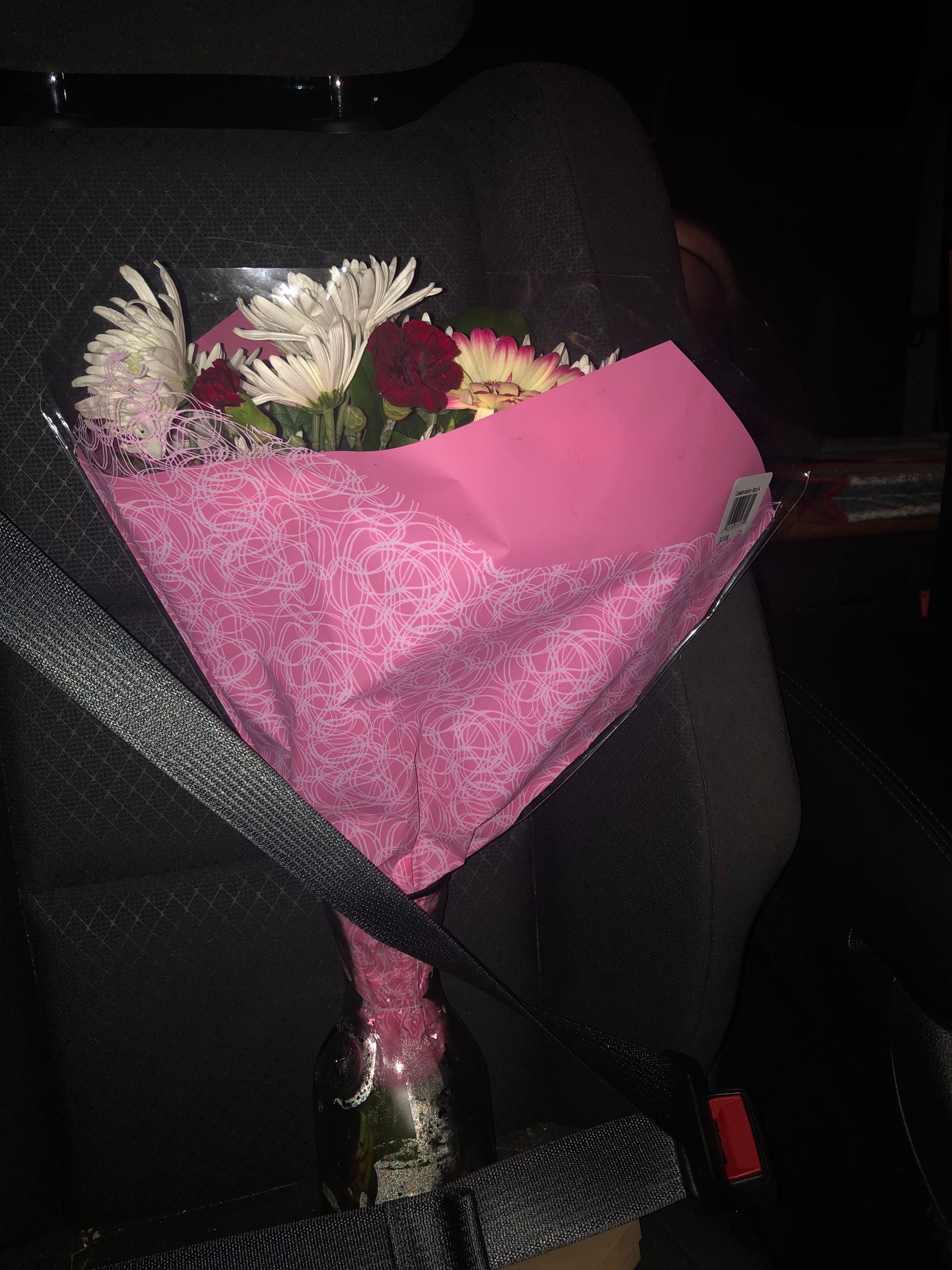 A delivery man is handing a box to a woman.