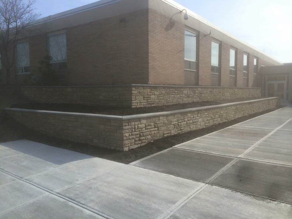 A brick building with a concrete walkway leading to it