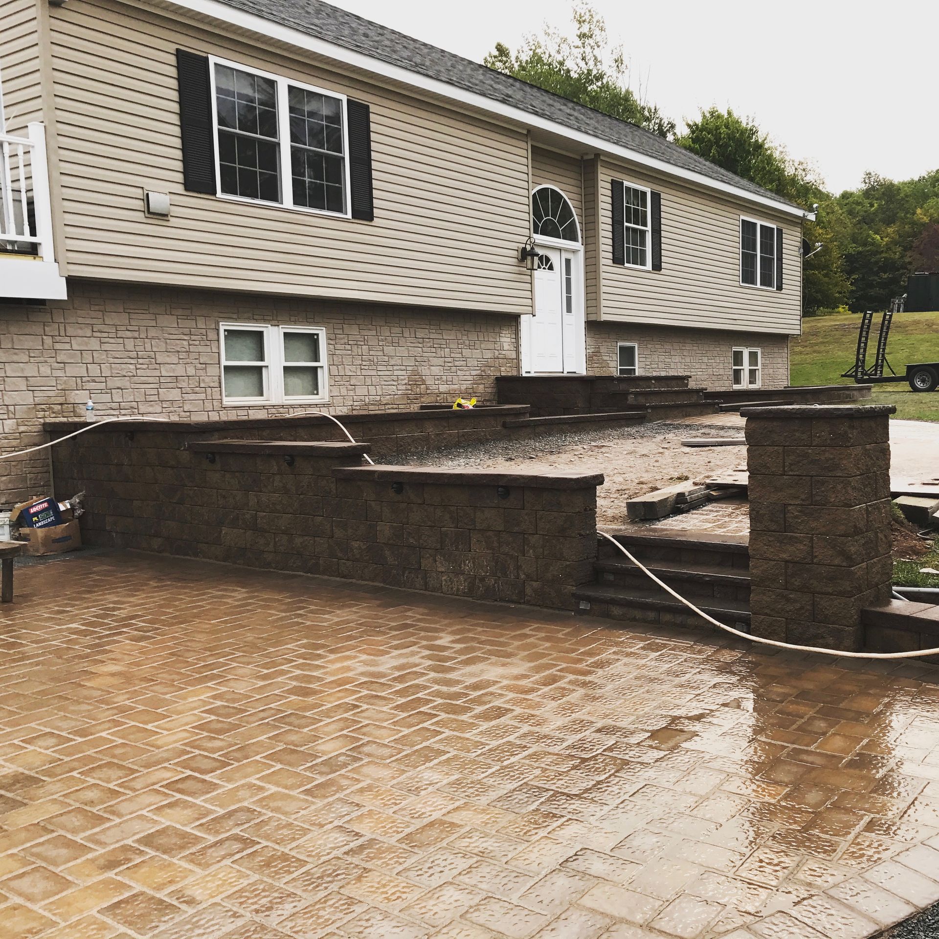 A house with a brick patio in front of it