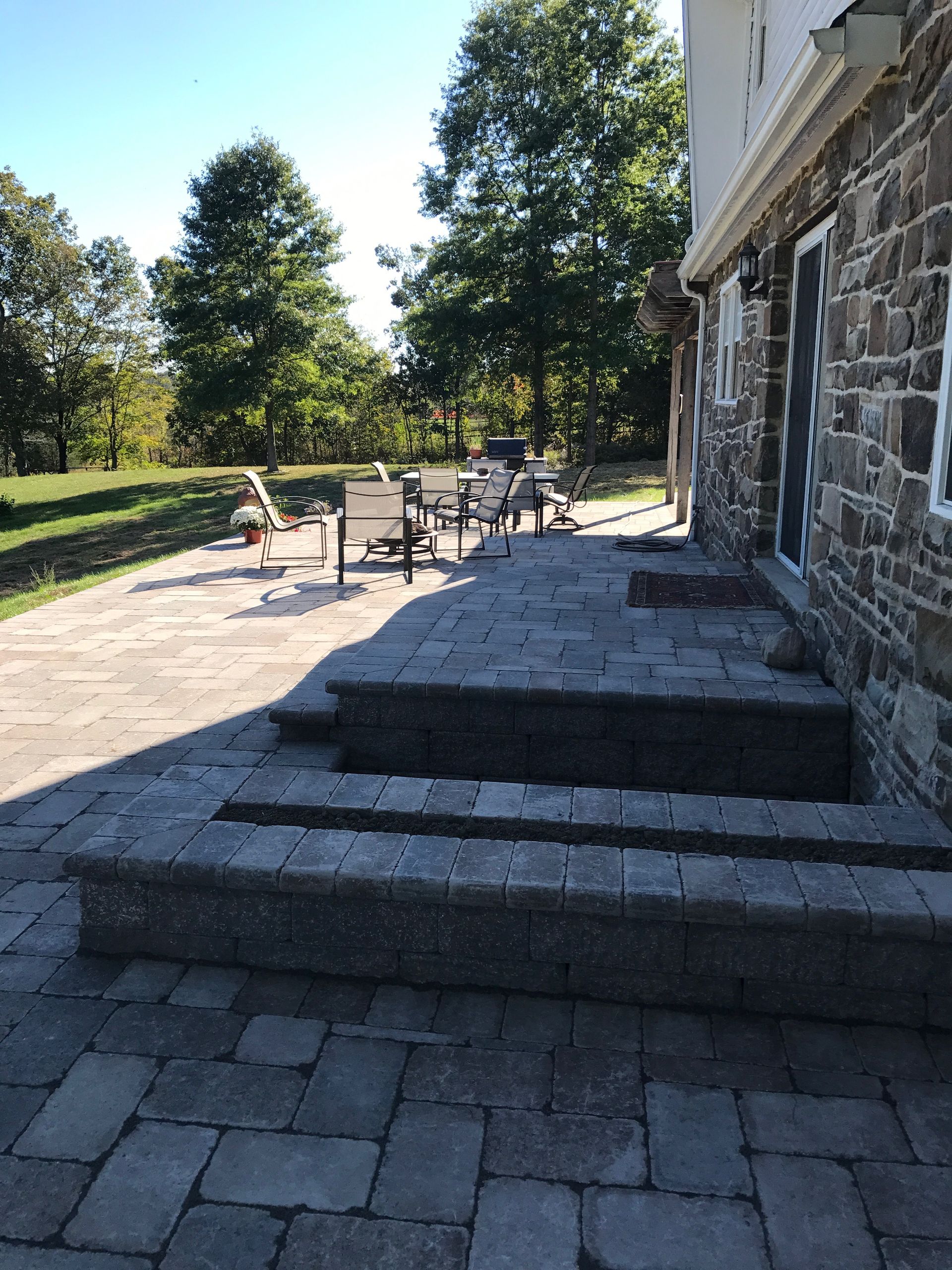 A stone patio with stairs leading up to it