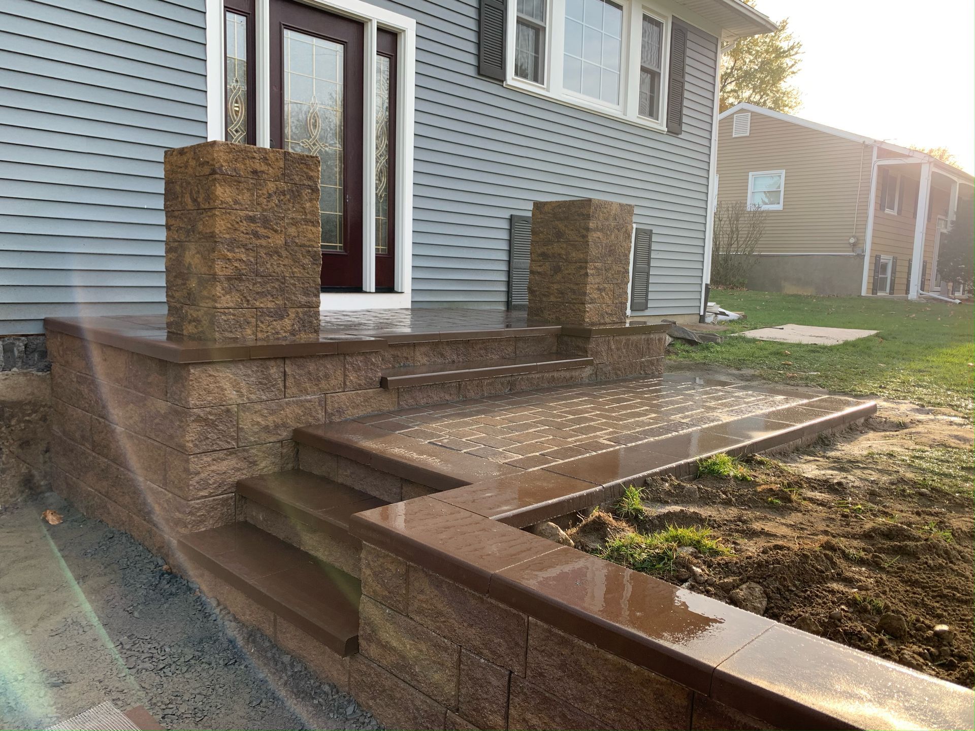 A house with a porch and stairs in front of it.