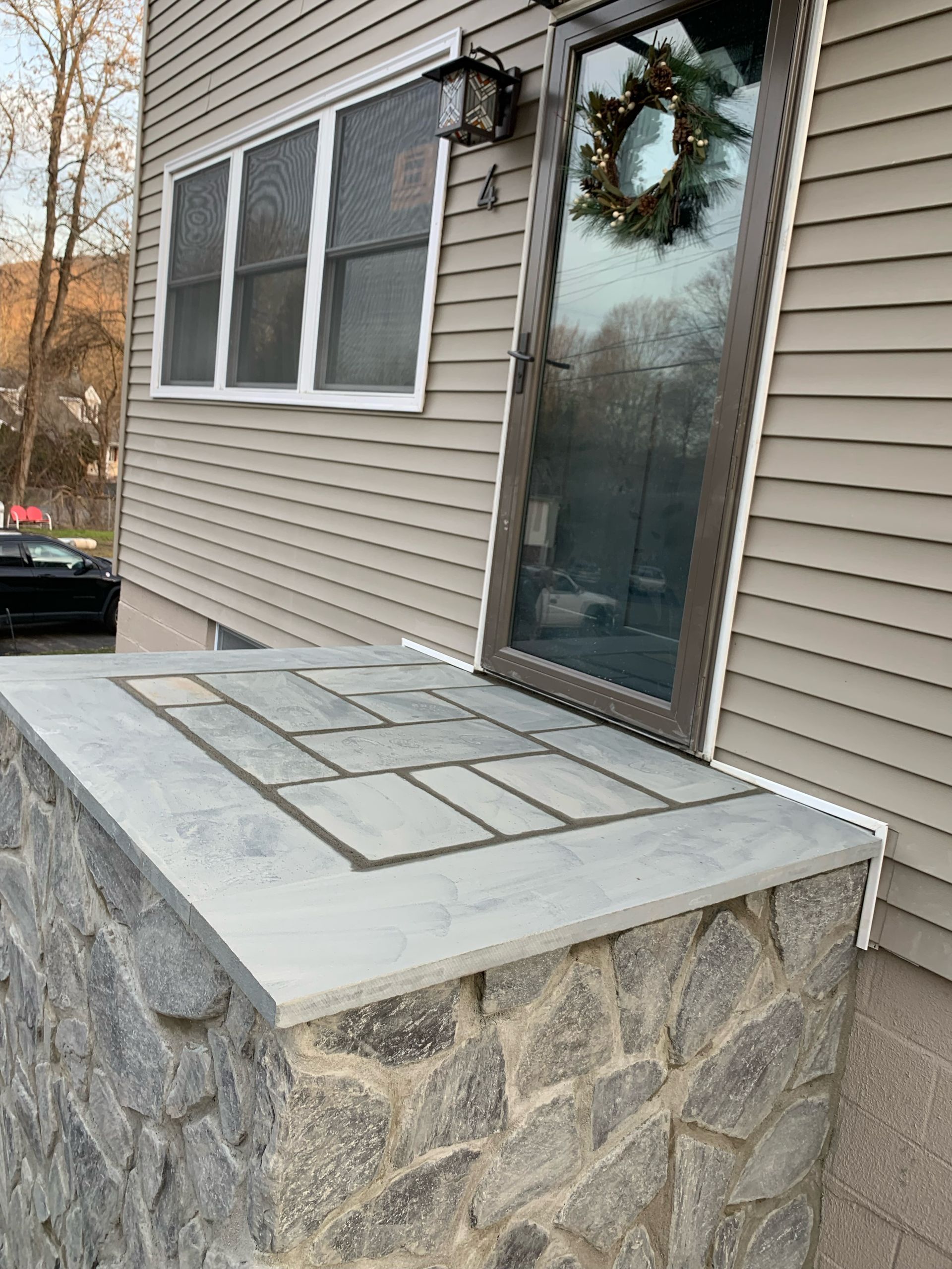 There is a wreath on the door of the house.