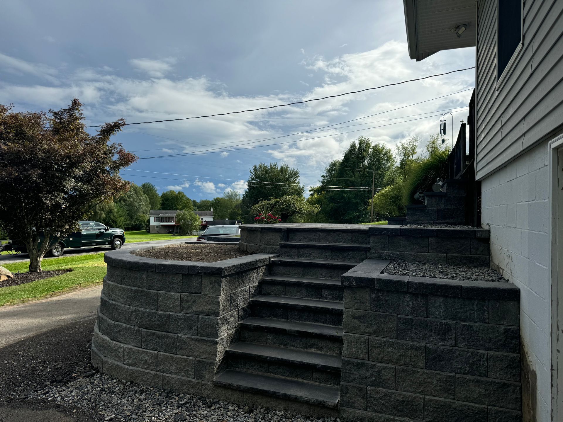A brick wall with stairs leading up to a house.
