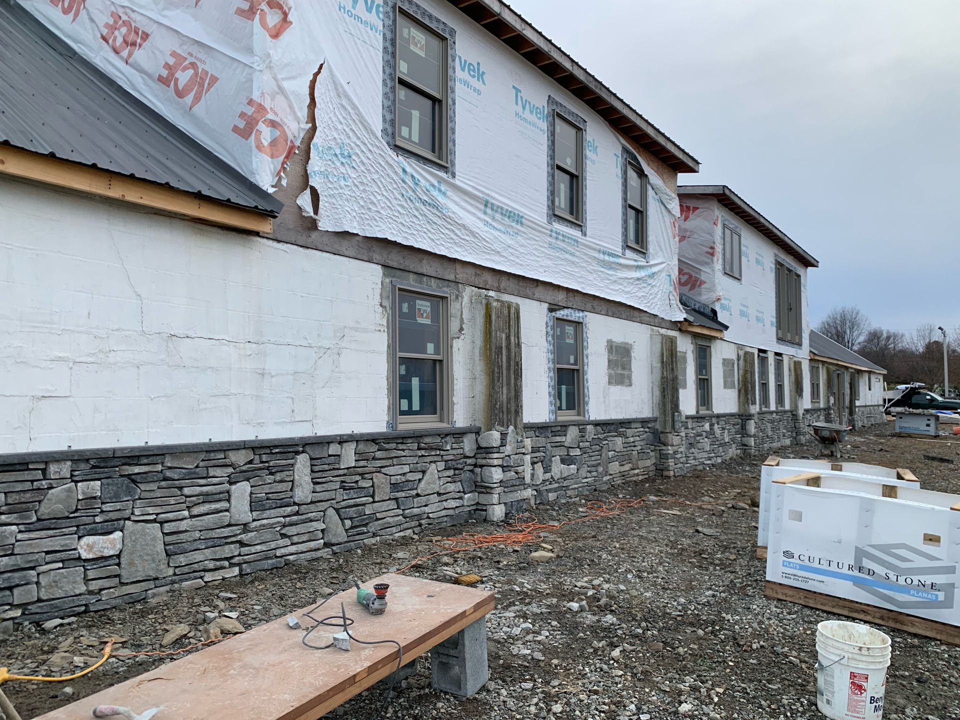A building under construction with a lot of windows and a table in front of it.