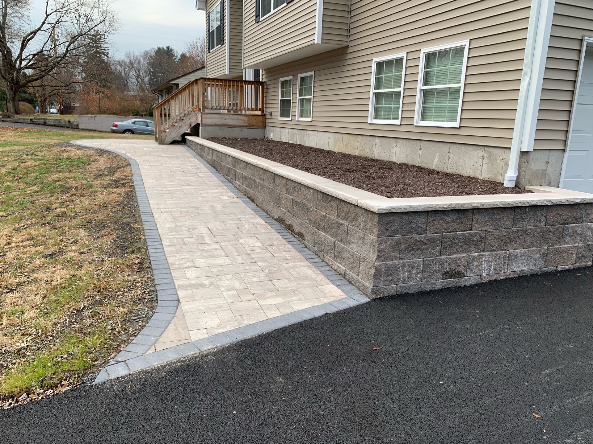 There is a walkway leading to the front of the house.