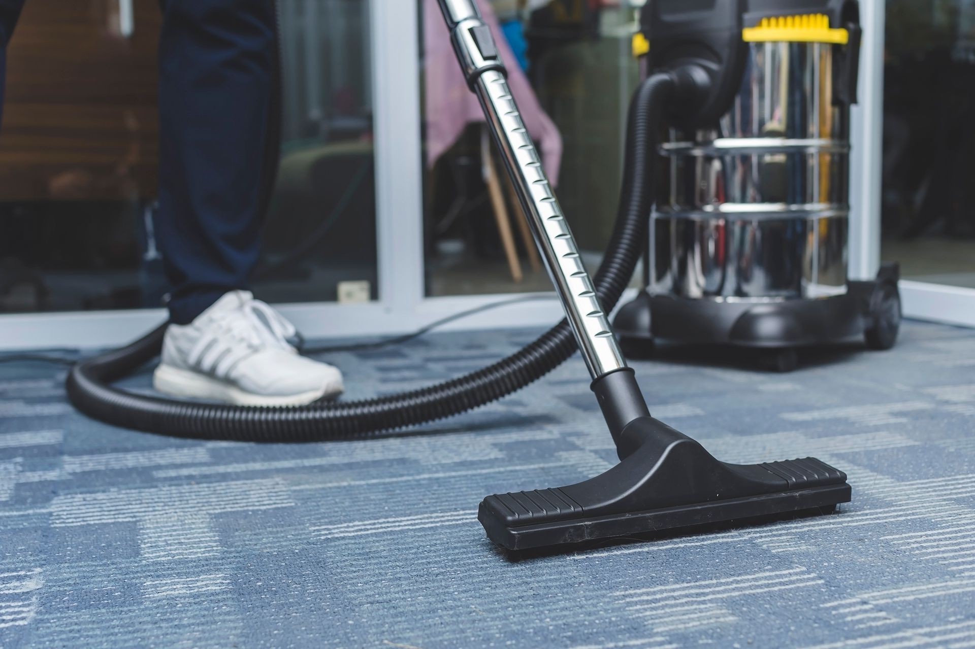 a person is using a vacuum cleaner to clean a carpet