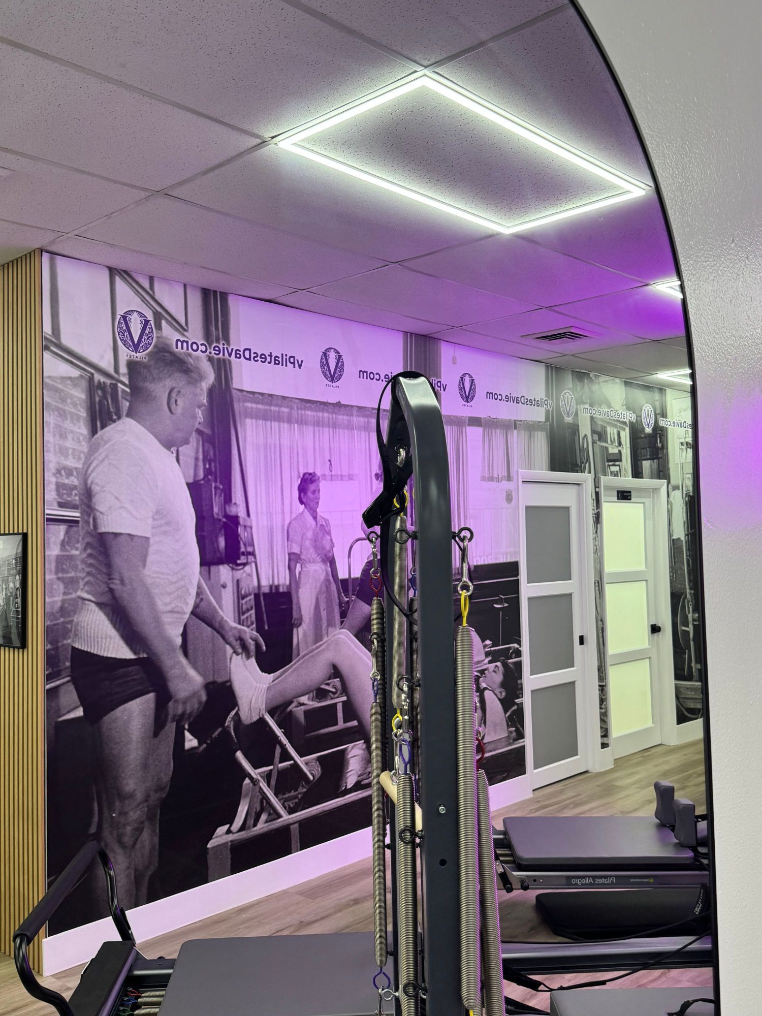 A large Pilates studio filled with lots of Pilates exercise equipment.