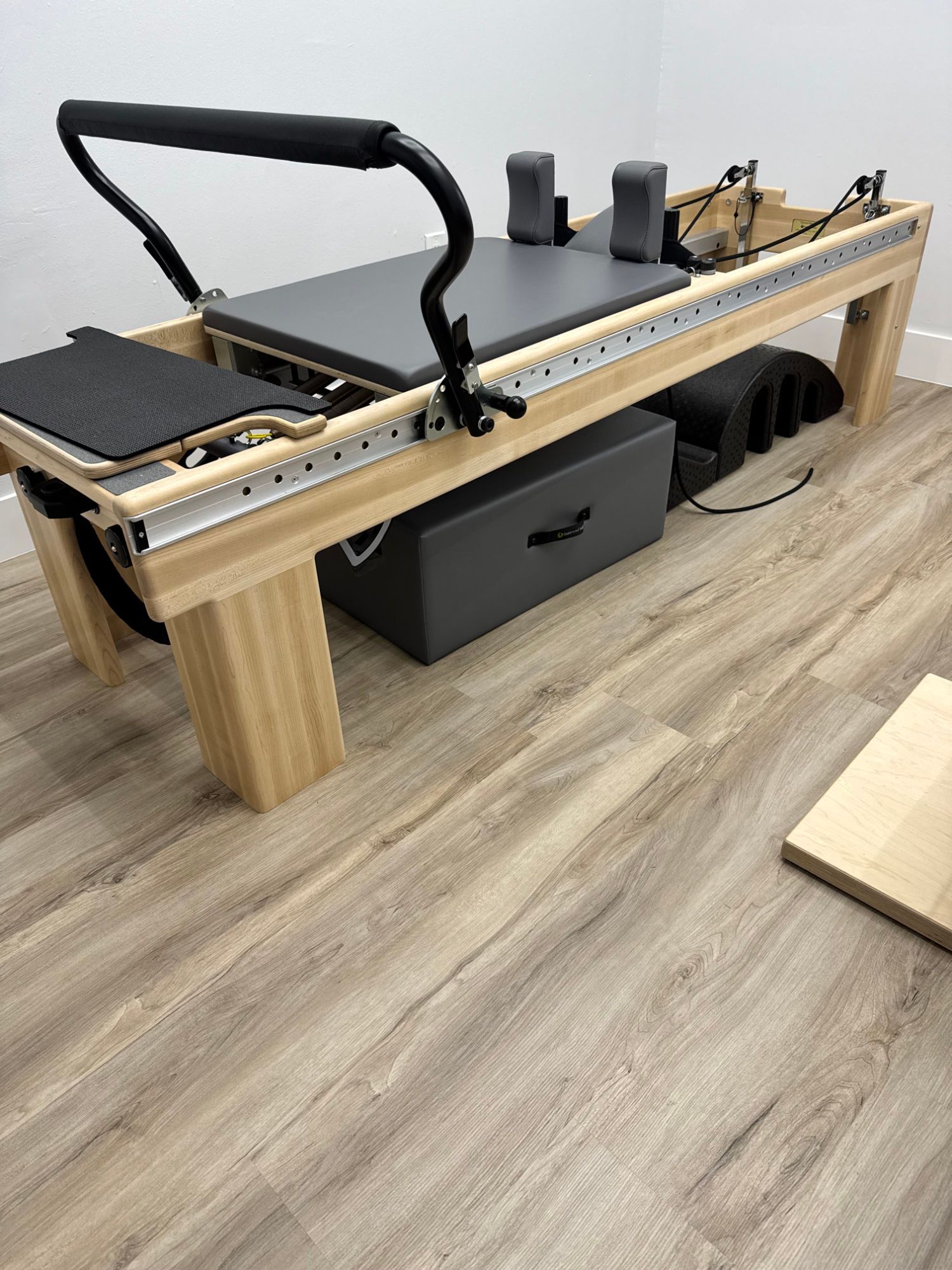 A Pilates studio filled with lots of Pilates equipment and mirrors.