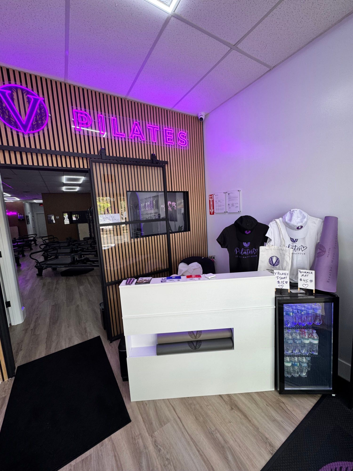 A display of toe socks hanging on a wall above a shelf