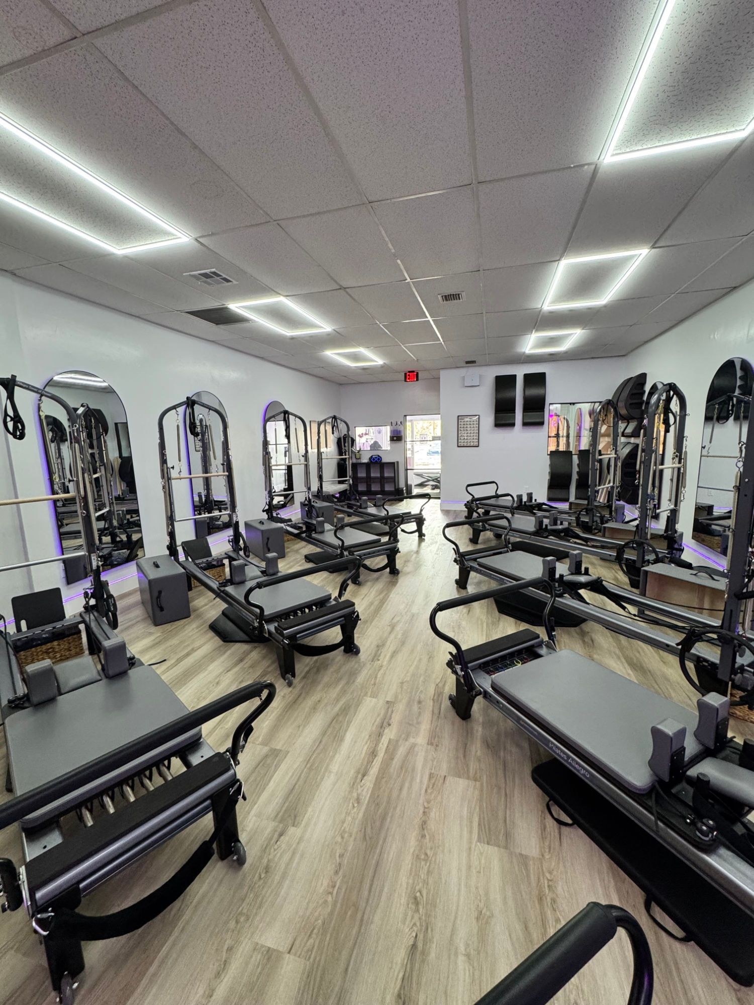 A group of people are doing pilates in a studio.