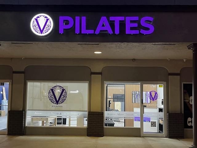 The outside of V pilates studio at night