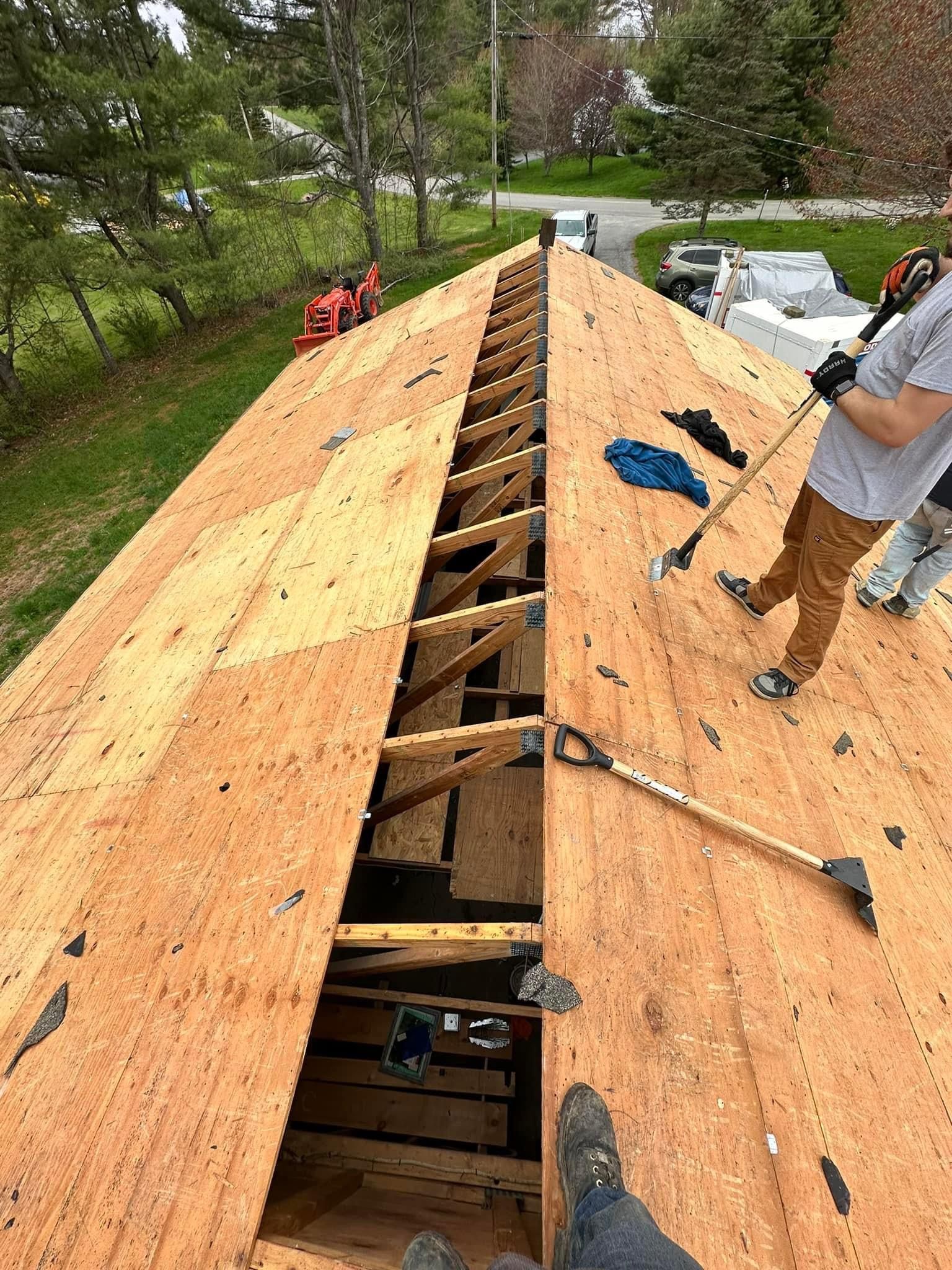 A man is working on the roof of a house.