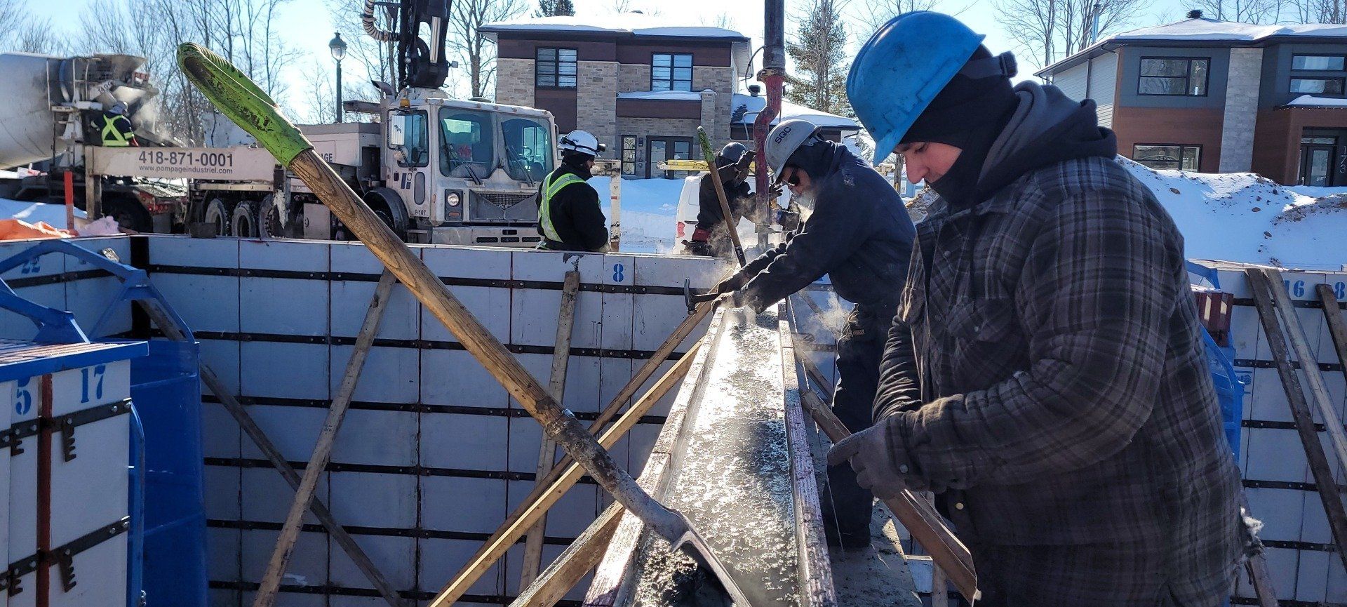 Un groupe d'ouvriers du bâtiment travaillent sur un bâtiment dans la neige.