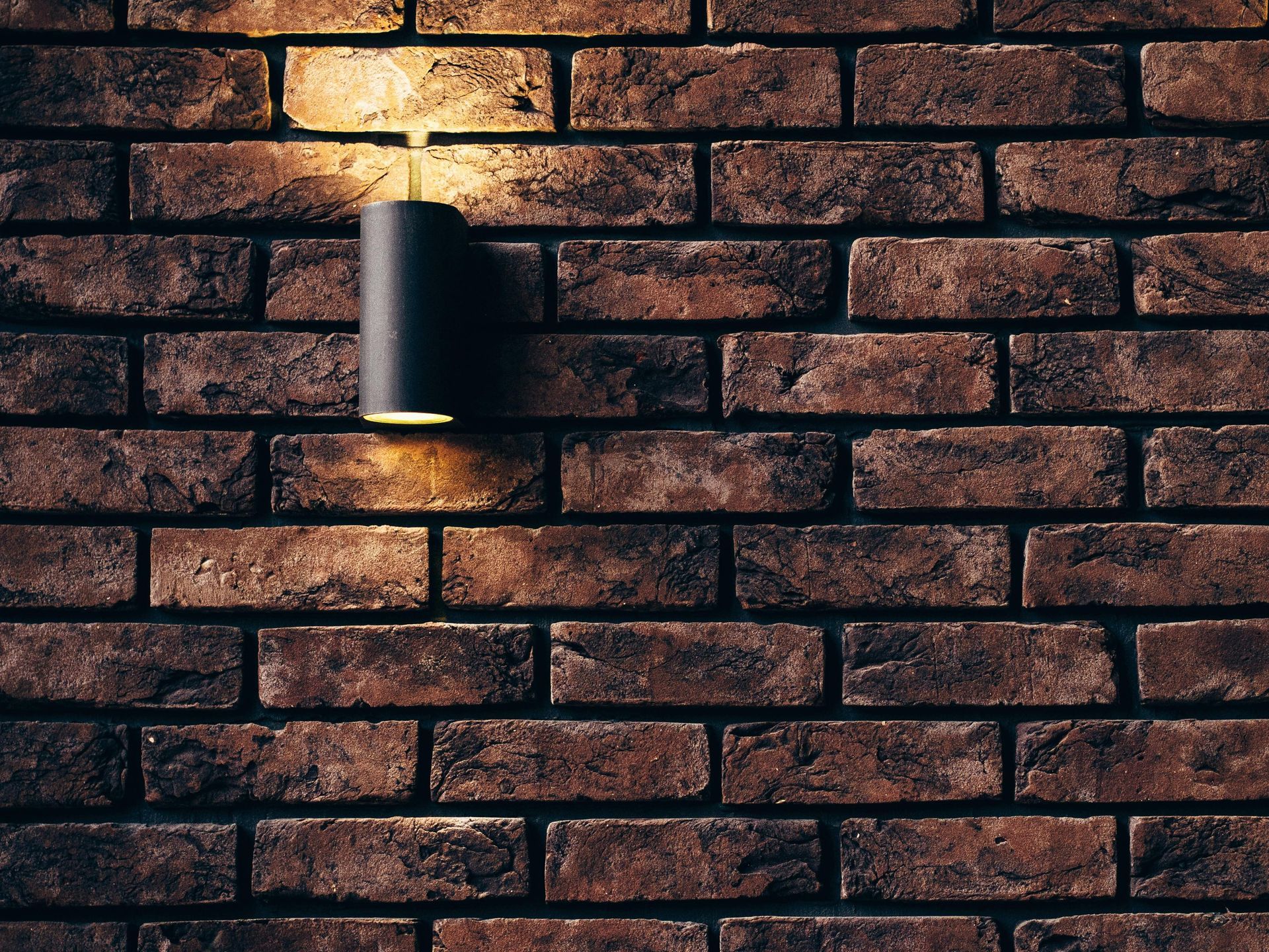 A brick wall with a light on it.
