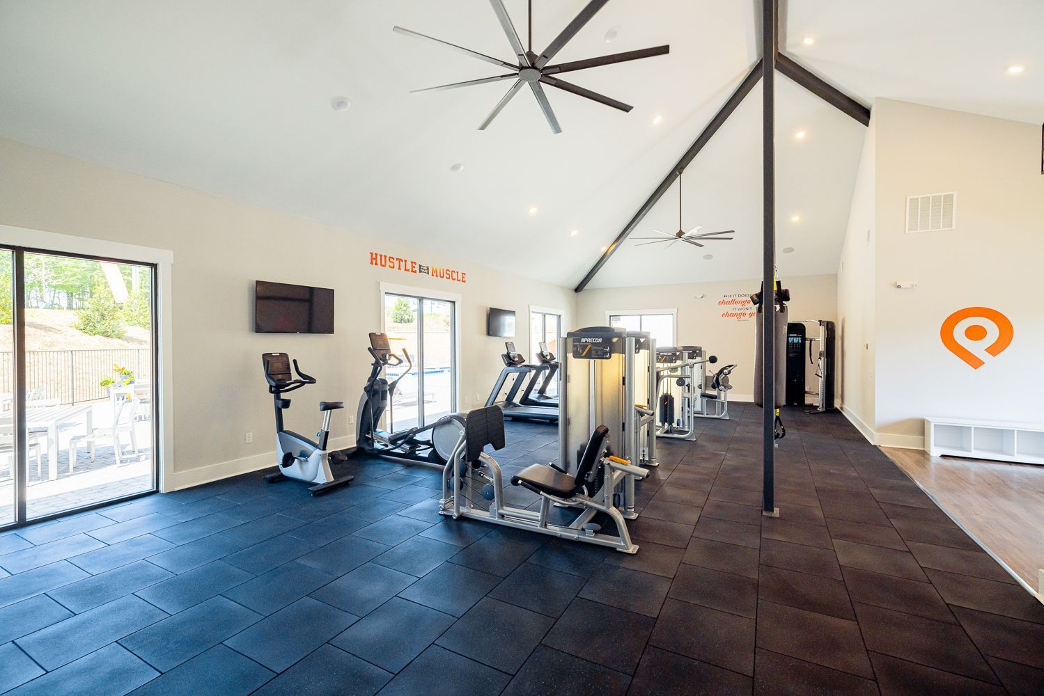Pointe Grand Kingsland East Apartment Homes 24-Hour fitness center with large ceiling fan and workout machines.