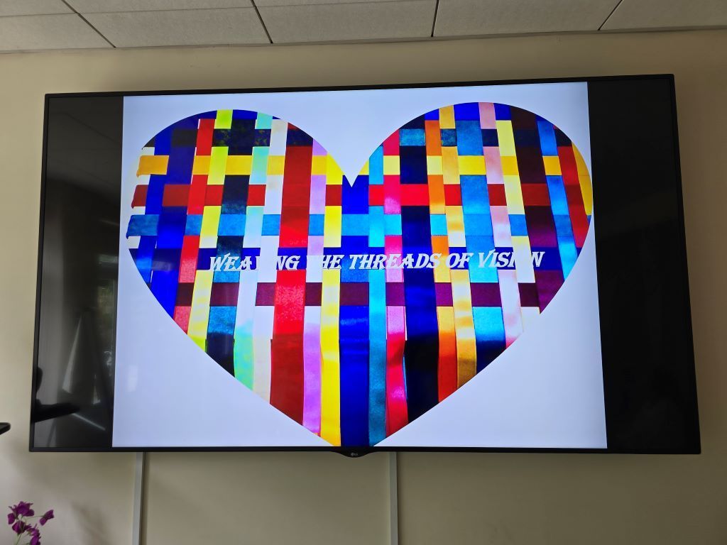 A tv screen shows a colorful heart and the words 