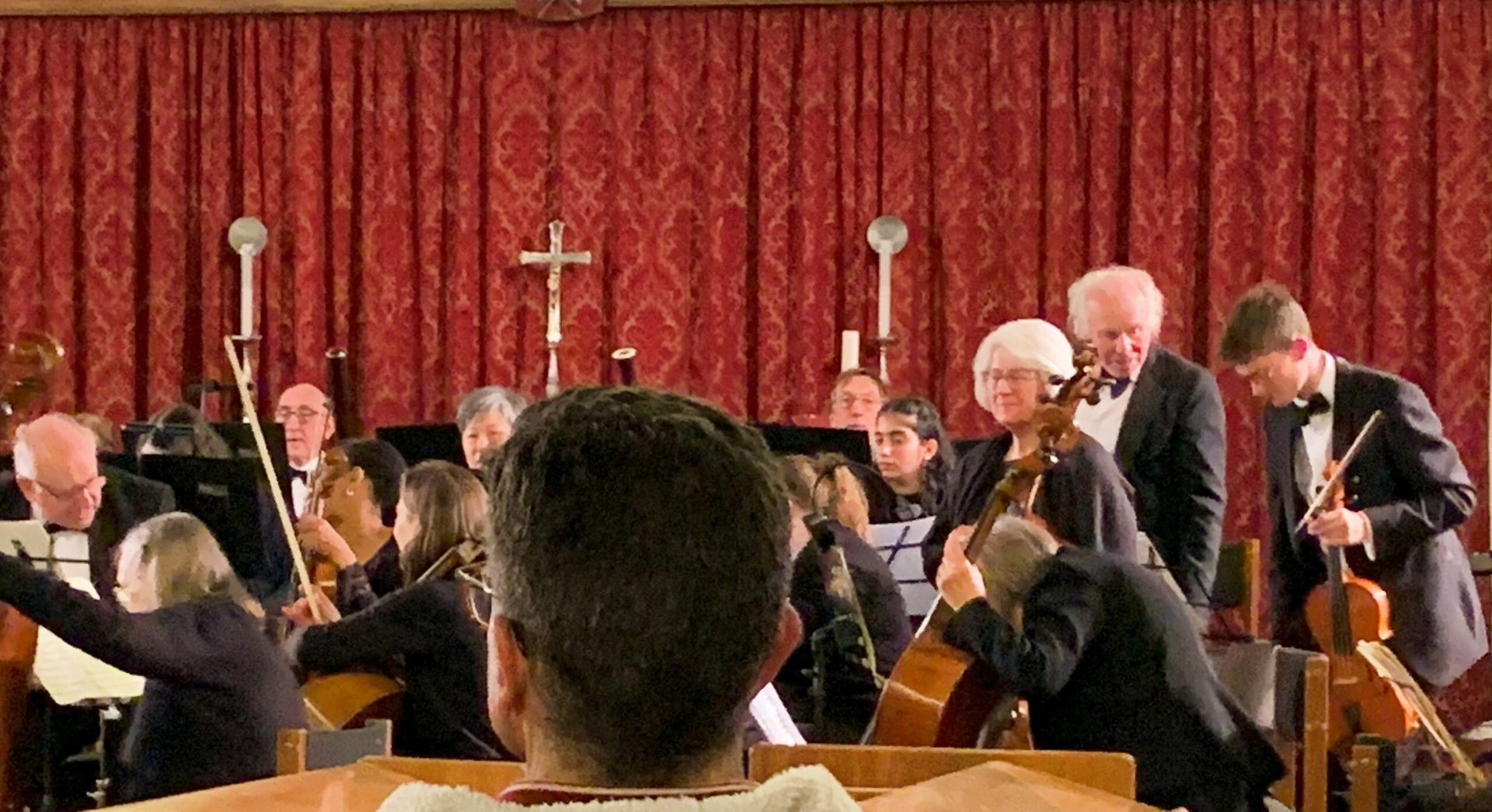 a man is watching an orchestra perform in a church .