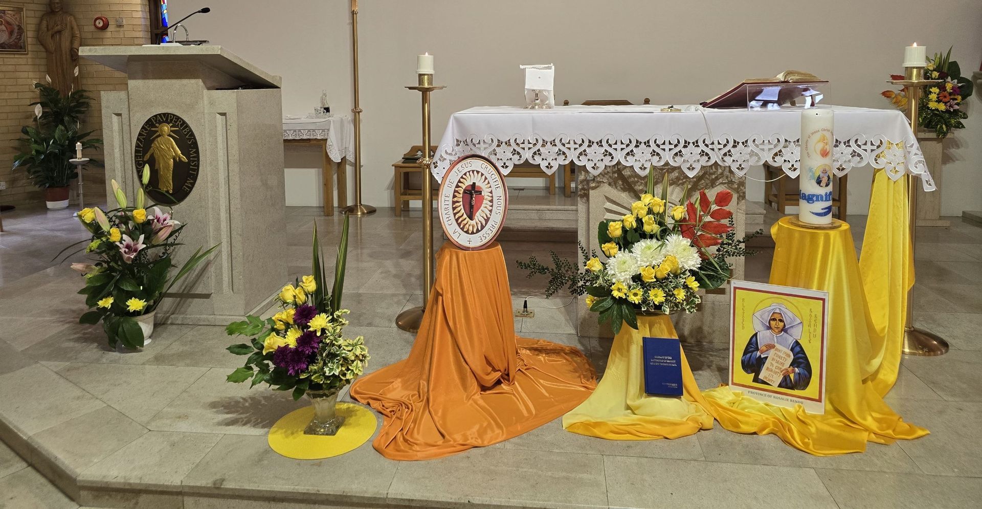 A church altar decorated with flowers and a candle