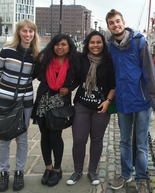 A group of people posing for a picture with one woman wearing a shirt that says no family