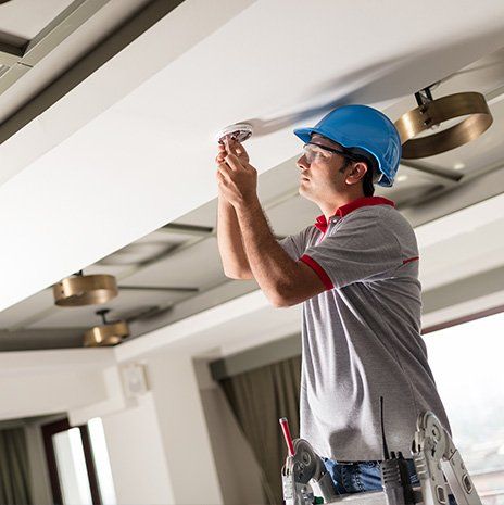 Man Installing Smoke Detector — Valley Cottage, NY — Inter County Alarm Systems