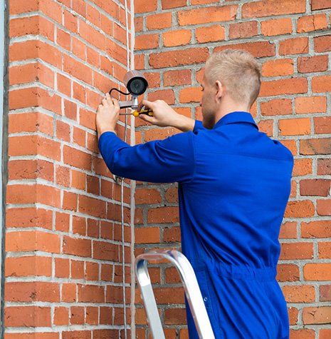 Man Fixing CCTV Position — Valley Cottage, NY — Inter County Alarm Systems