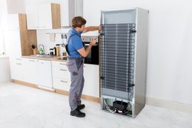 Man Repairing Refrigerator