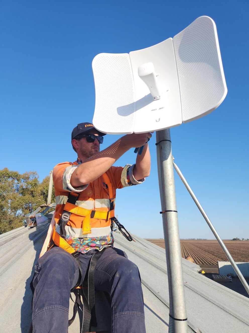 Technician Installing CelFi Tower — Frontier Connect in Newtown, QLD