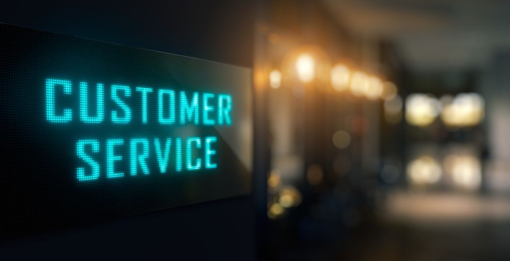 A Sign That Says Customer Service is Lit Up in a Dark Room — Frontier Connect in Newtown, QLD