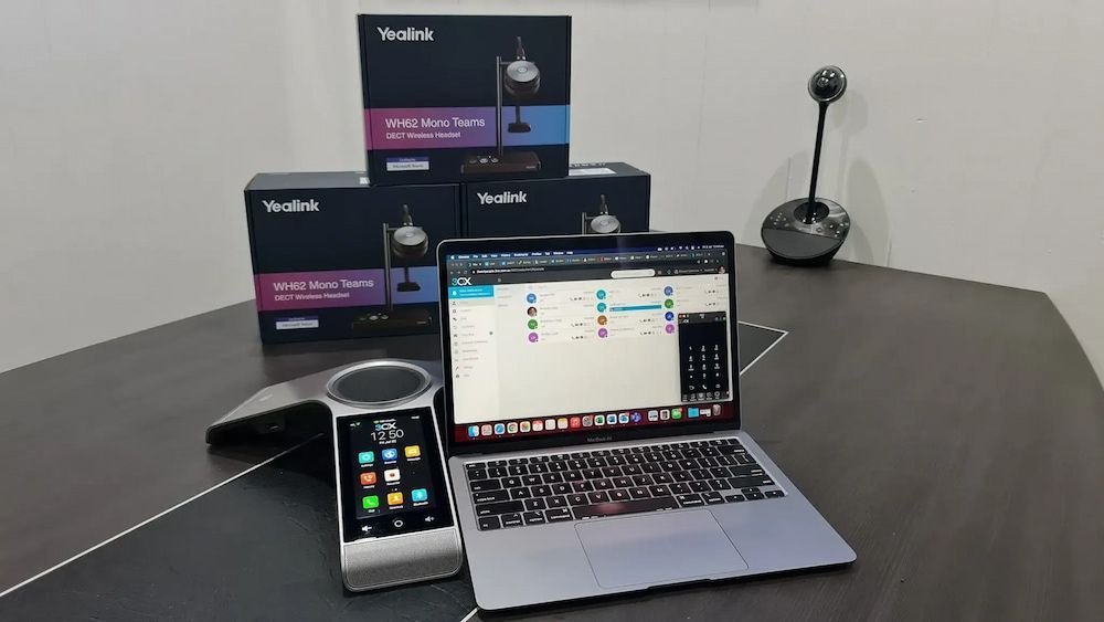 A Laptop Computer is Sitting on a Table Next to a Phone — Frontier Connect in Newtown, QLD