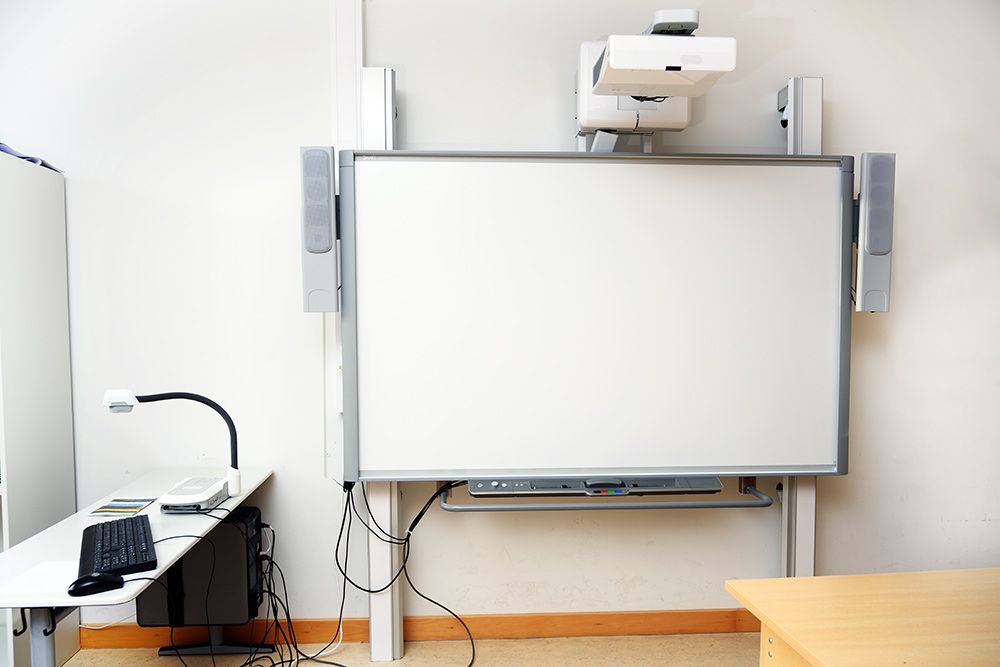 An Empty Classroom With a White Board and Projector — Frontier Connect in Chinchilla, QLD