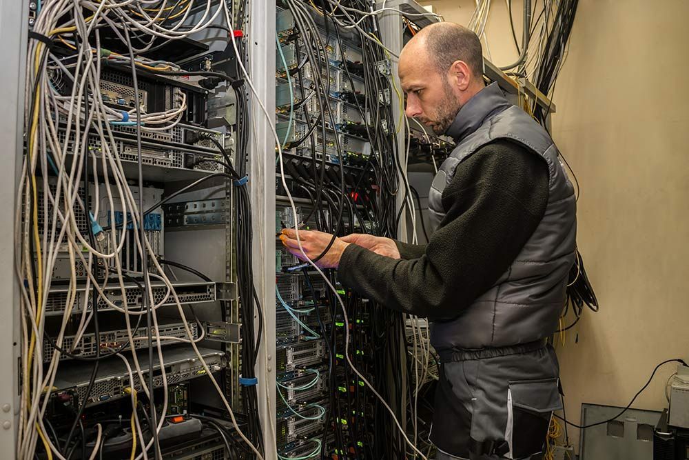 A Man is Working on a Server in a Server Room — Frontier Connect in Chinchilla, QLD